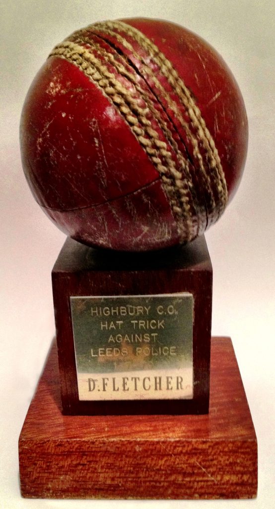 A cricket ball mounted on a wooden plinth, engraved Highbury C.C. Hat Trick Against Leeds Police, D. Fletcher