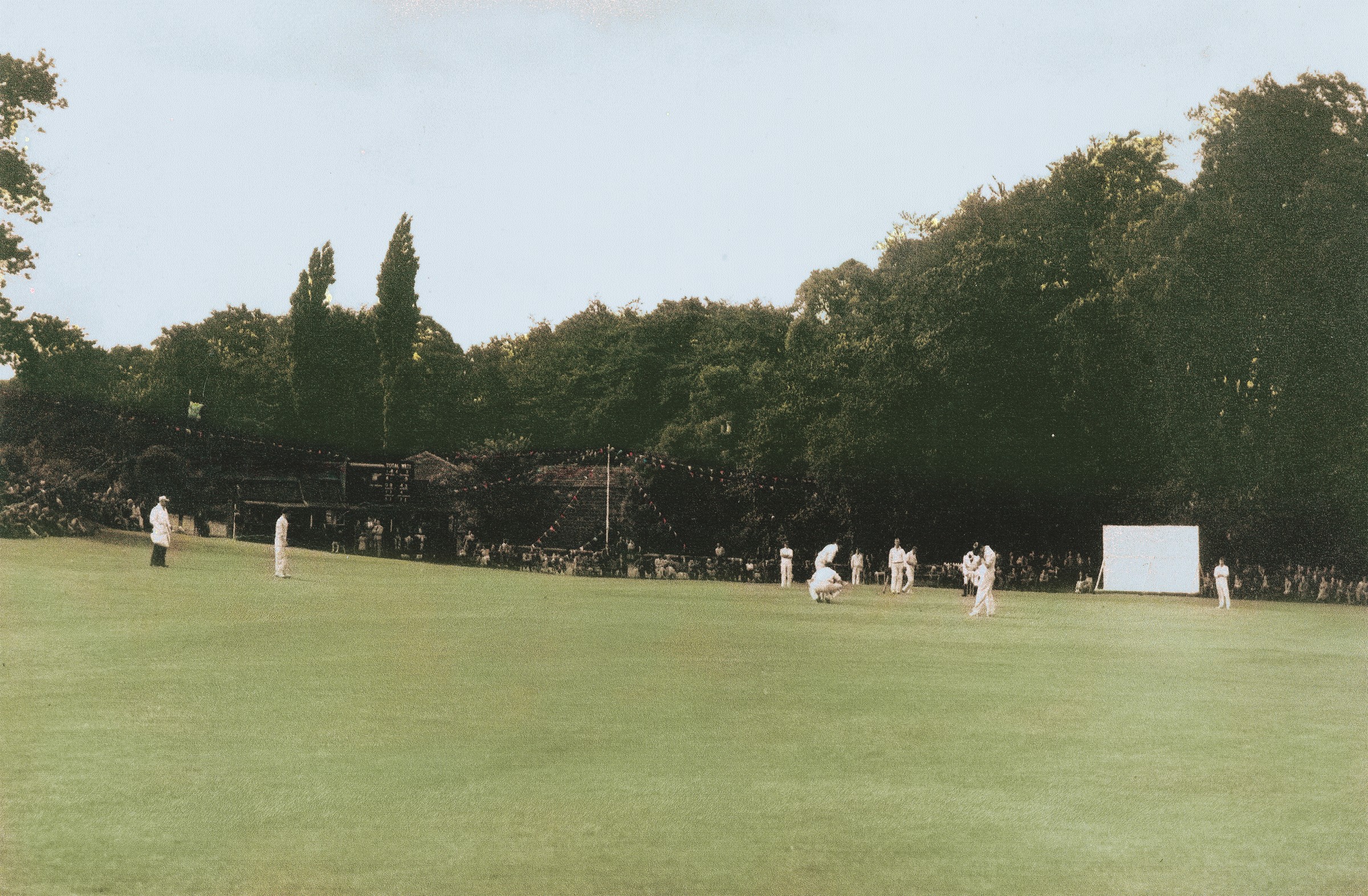 A match day at Highbury, bunting strung along the boundary and spectators lining the bank